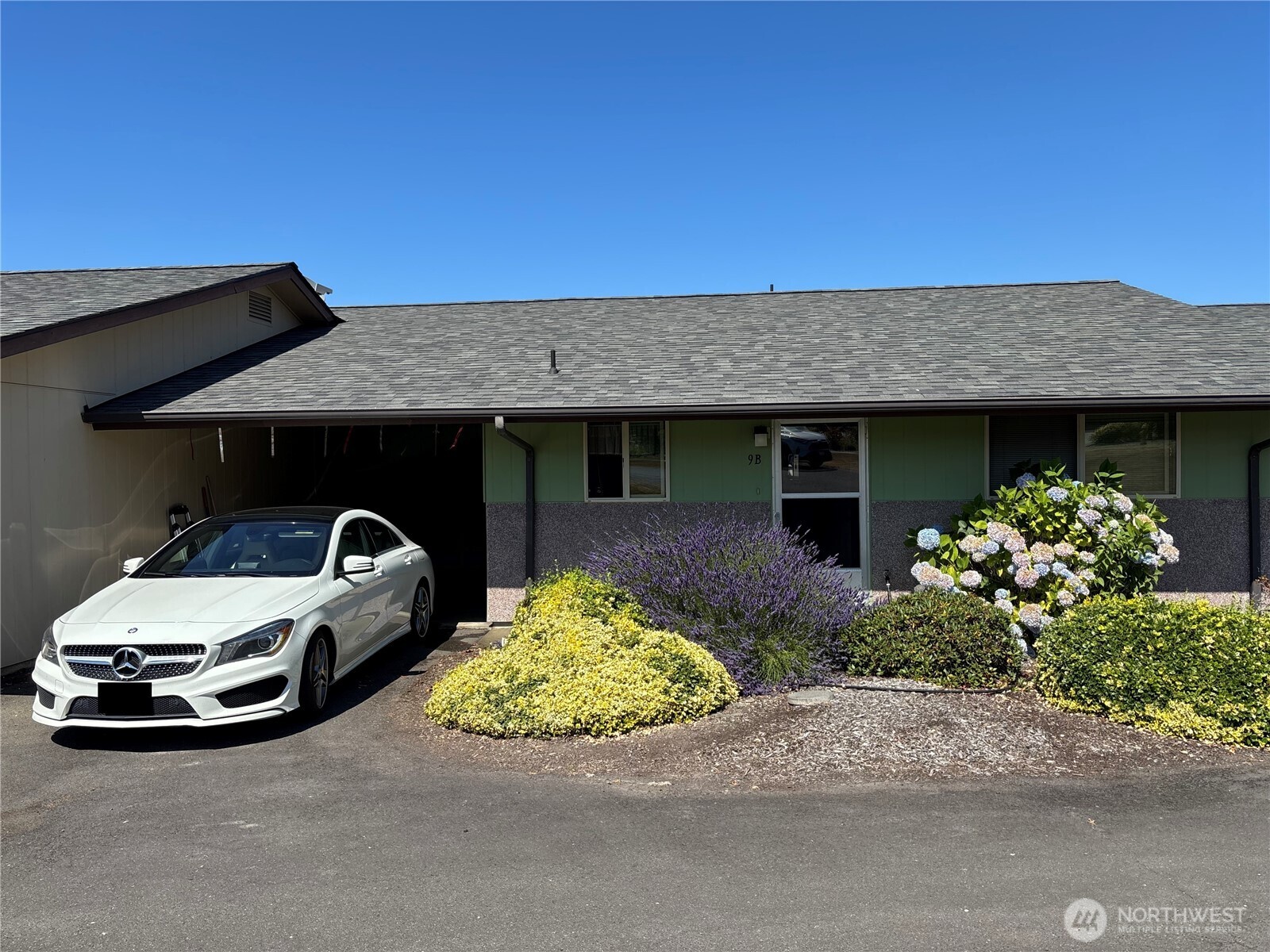 1301 South 3rd Avenue, Unit 9B Sequim, WA 98382 - Photo 39 of 39 a front view of a house with garden