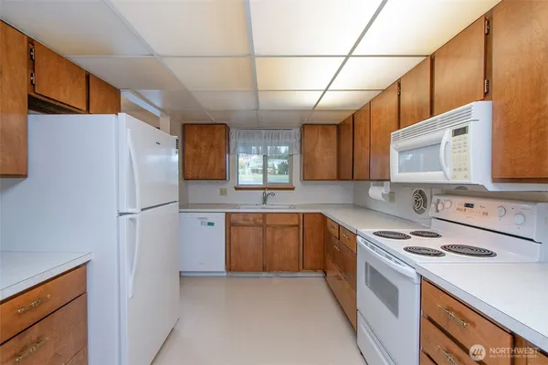 a kitchen with stainless steel appliances a refrigerator sink and stove