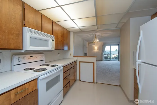 a kitchen with stainless steel appliances a stove microwave and cabinets