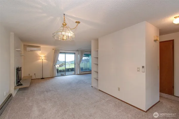 a view of a room with window and chandelier