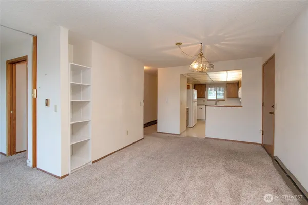 an empty room with a empty space and windows