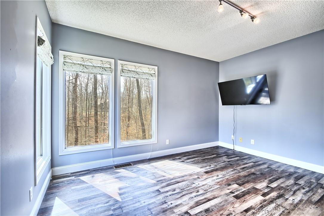8711 Nicole Lane Springboro, OH 45066 - Photo 24 of 87 This bright room features beautiful flooring and expansive windows, offering tranquil views of the surrounding trees.