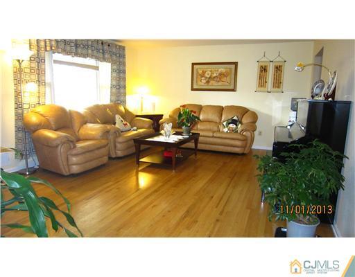 24 Roxy Avenue Edison, NJ 08820 - Photo 2 of 15 a living room with furniture and a flat screen tv