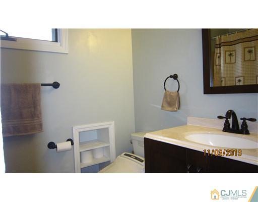 24 Roxy Avenue Edison, NJ 08820 - Photo 15 of 15 a black and white photo of a bathroom