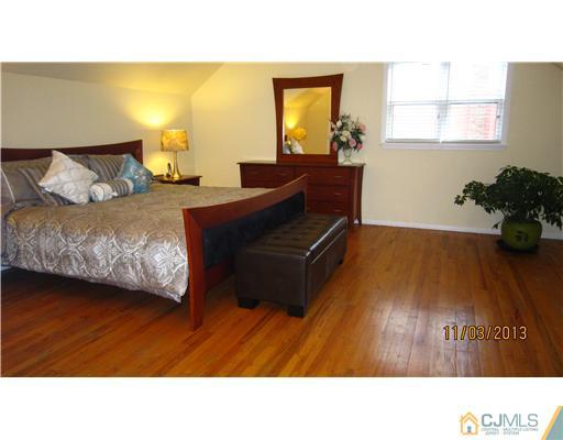 24 Roxy Avenue Edison, NJ 08820 - Photo 7 of 15 a living room with a bed furniture and a potted plant