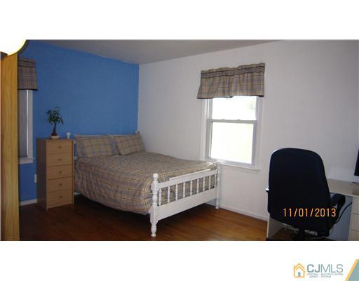 24 Roxy Avenue Edison, NJ 08820 - Photo 9 of 15 a bedroom with a bed and window