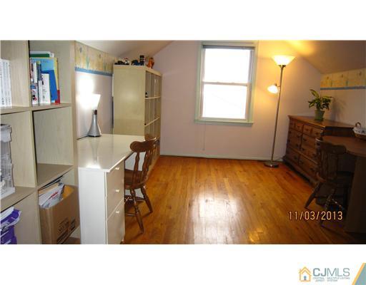 24 Roxy Avenue Edison, NJ 08820 - Photo 10 of 15 a black and white photo of a living room