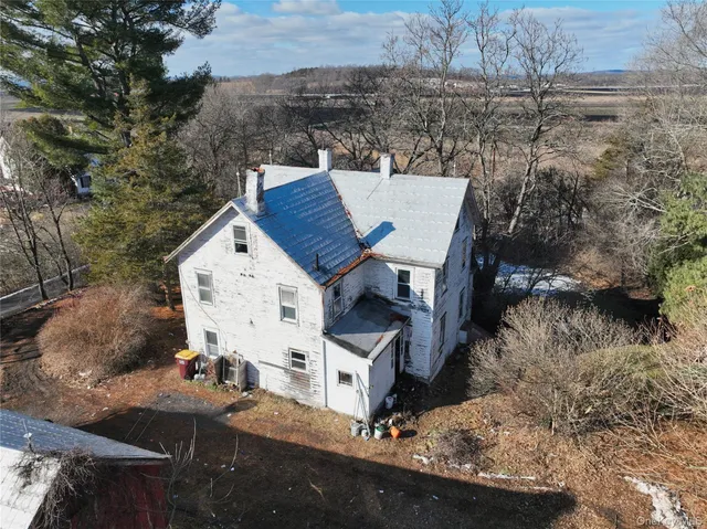 an aerial view of a house with yard and garage