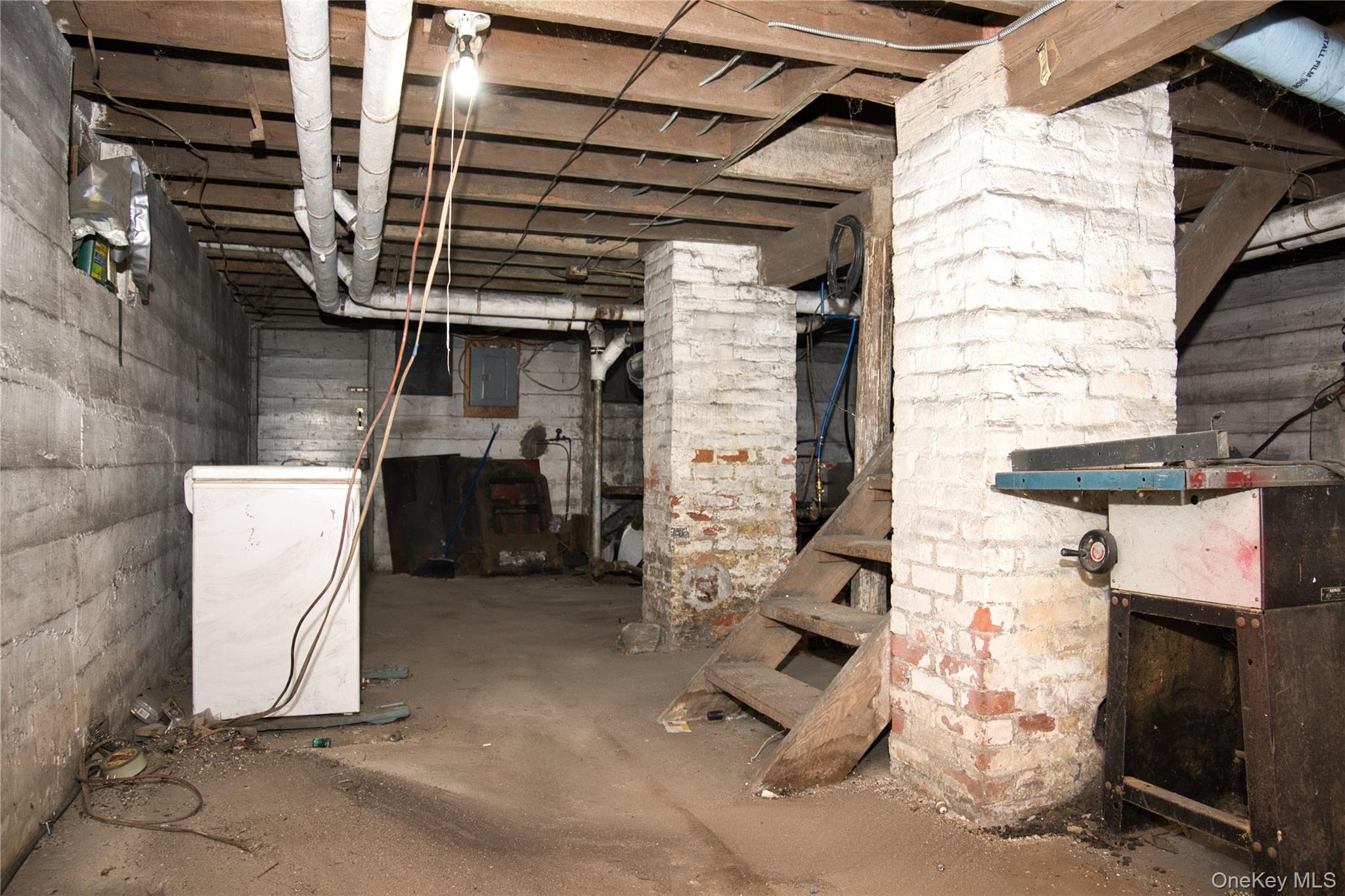 256 Round Hill Road Florida, NY 10921 - Photo 12 of 14 Unfinished below grade area with white refrigerator and electric panel