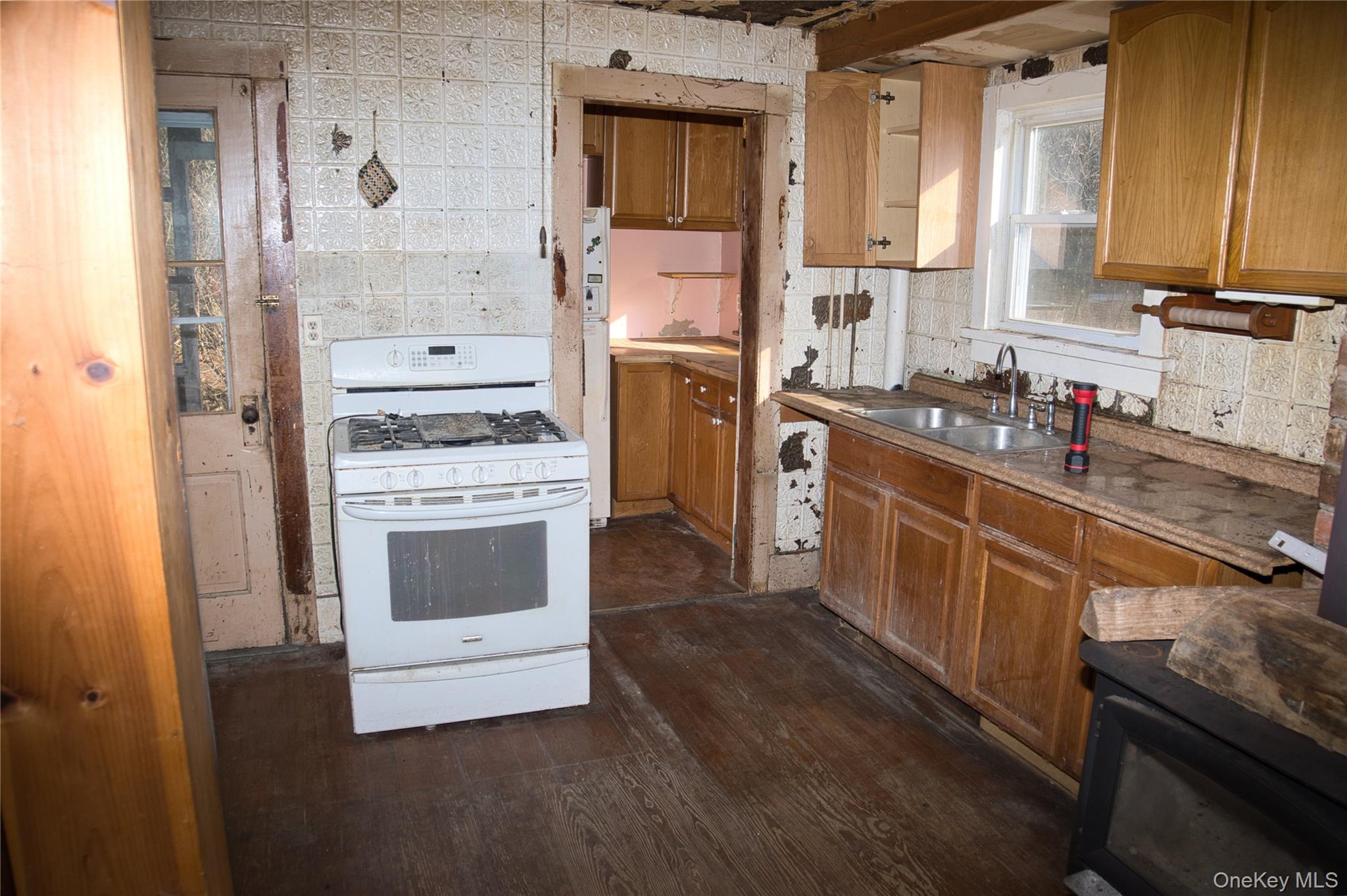 256 Round Hill Road Florida, NY 10921 - Photo 5 of 14 Kitchen featuring white appliances, brown cabinets, dark wood-style flooring, and tasteful backsplash