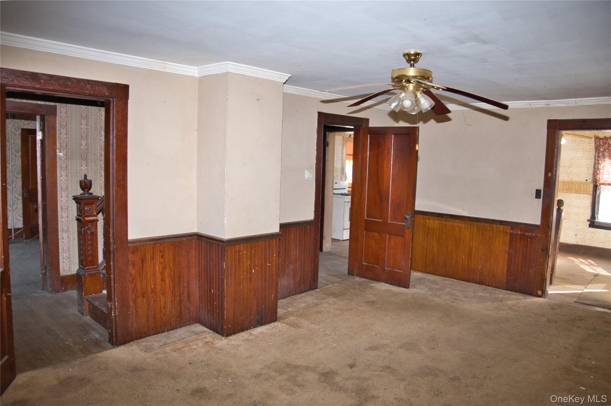 256 Round Hill Road Florida, NY 10921 - Photo 6 of 14 Spare room with a wainscoted wall, wooden walls, ornamental molding, a ceiling fan, and carpet floors