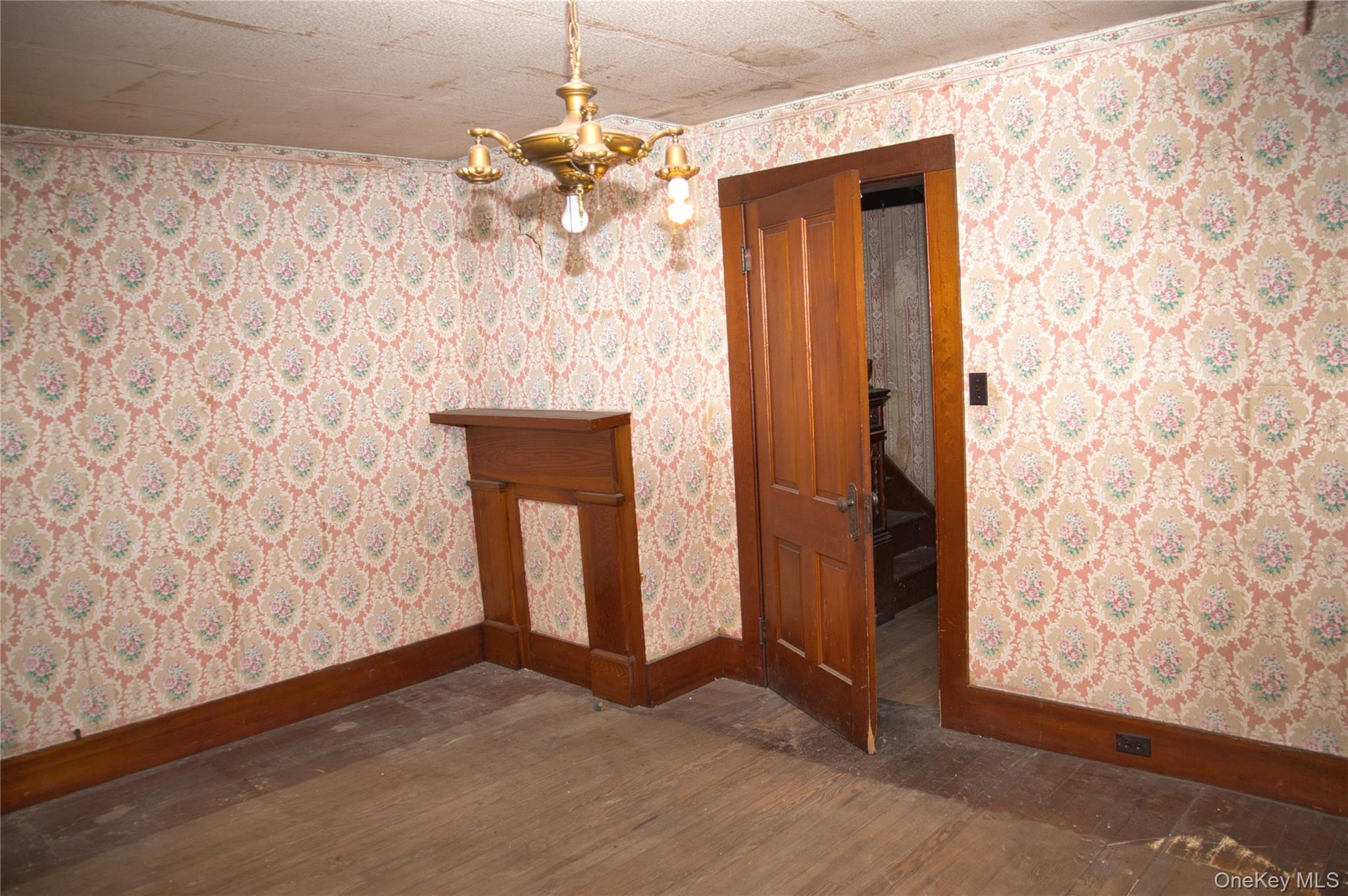 256 Round Hill Road Florida, NY 10921 - Photo 8 of 14 Unfurnished dining area with wallpapered walls, dark wood-style floors, and a chandelier