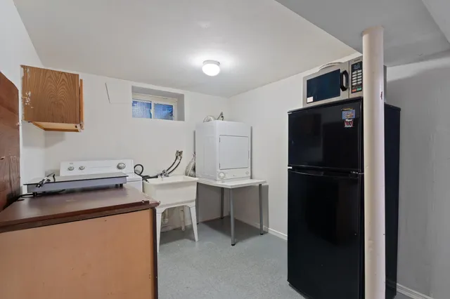 a room with a refrigerator and cabinets