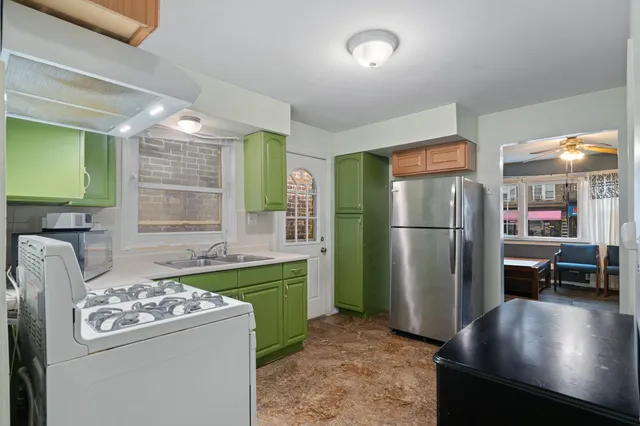 a kitchen with refrigerator and furniture