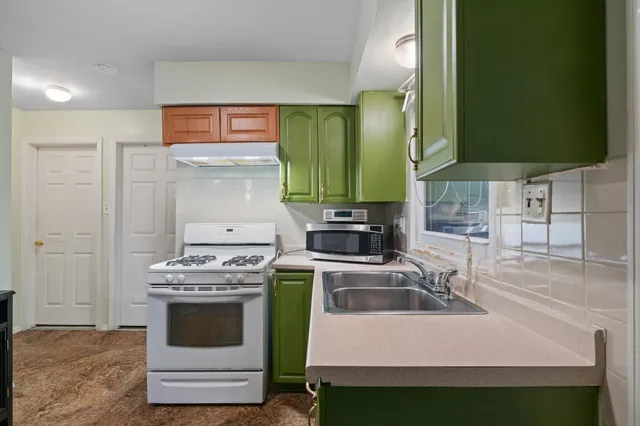 a kitchen with a stove and a sink