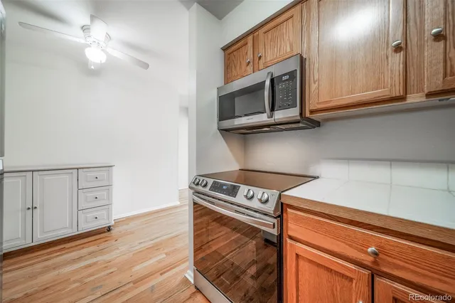 a kitchen with stainless steel appliances granite countertop a stove and a microwave