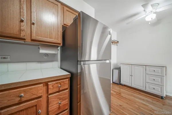 a view of a refrigerator in kitchen and wooden floor