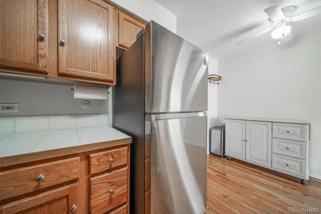 a view of a refrigerator in kitchen and wooden floor