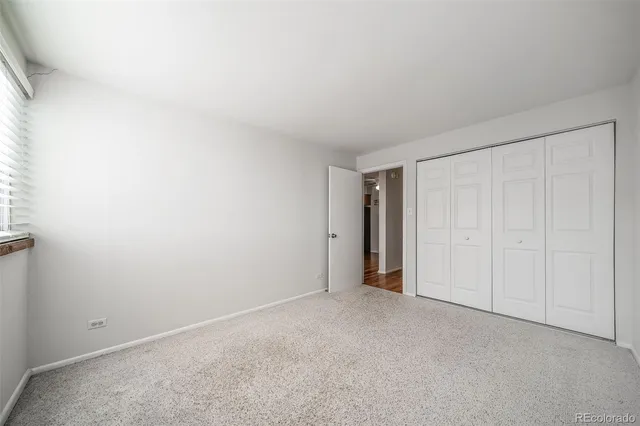 a view of an empty room and closet area