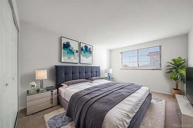 a bedroom with a large bed and a window