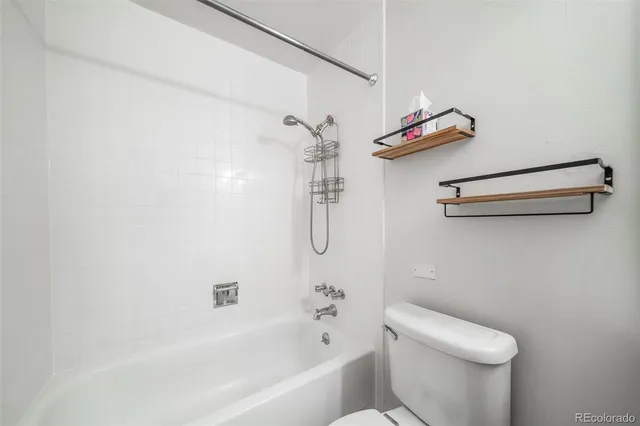 a bathroom with a shower a toilet and sink