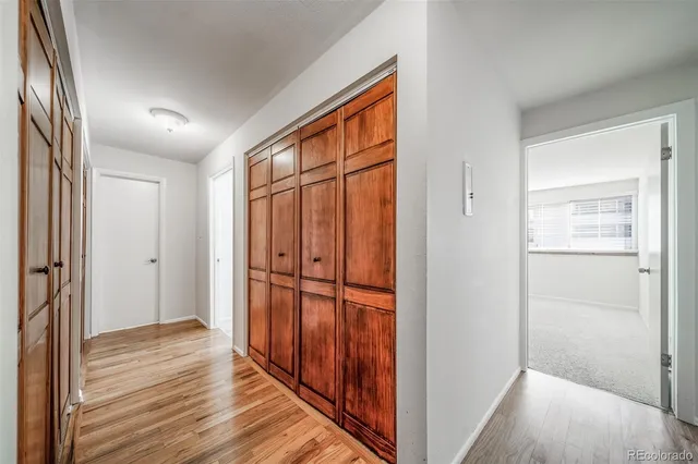a view of a hallway with wooden floor