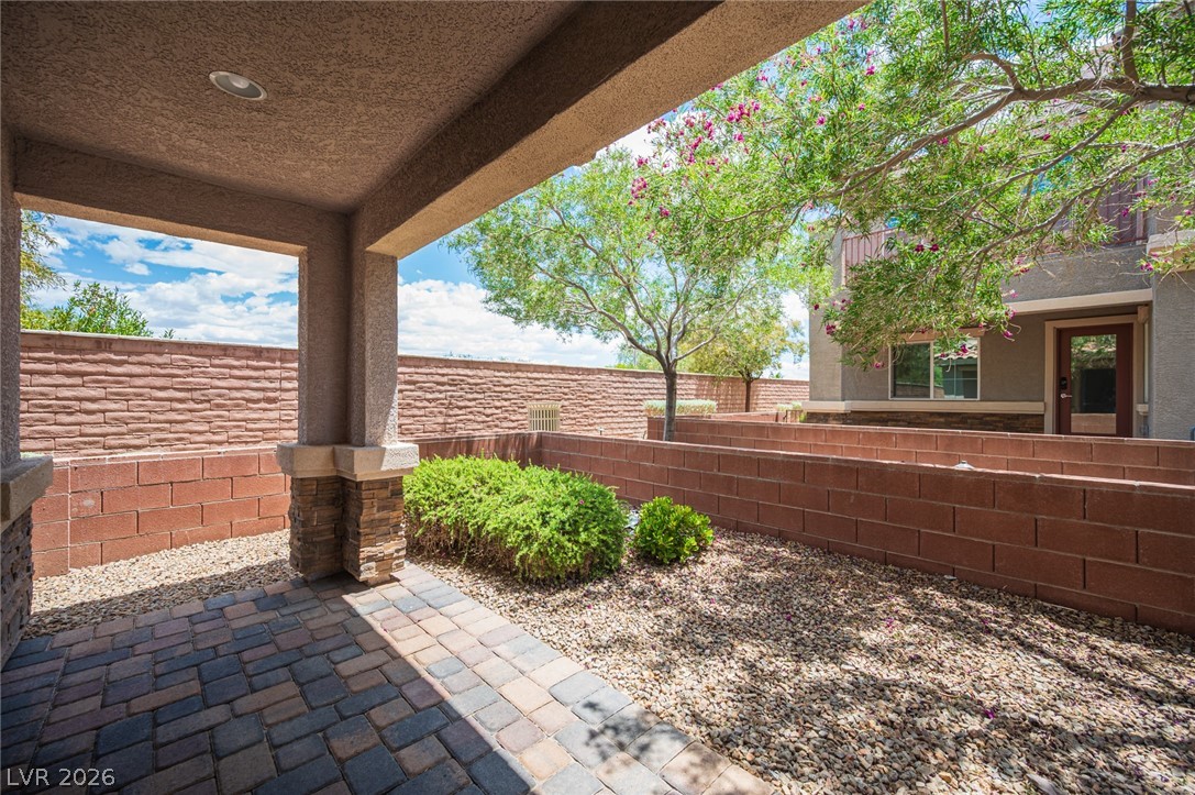 9916 Sable Point Street Las Vegas, NV 89178 - Photo 9 of 73 A welcoming patio with a paver floor and mature landscaping awaits outdoor enjoyment.