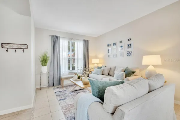a view of a dining room with furniture a chandelier and wooden floor