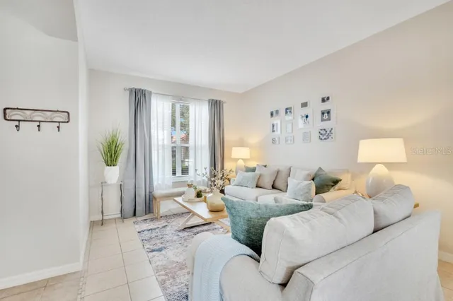 a view of a dining room with furniture a chandelier and wooden floor
