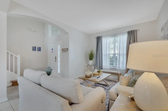 a large white kitchen with stainless steel appliances