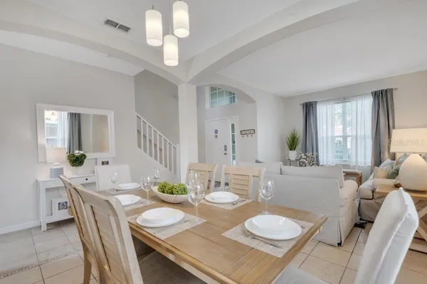 a kitchen with kitchen island granite countertop a table chairs sink and cabinets