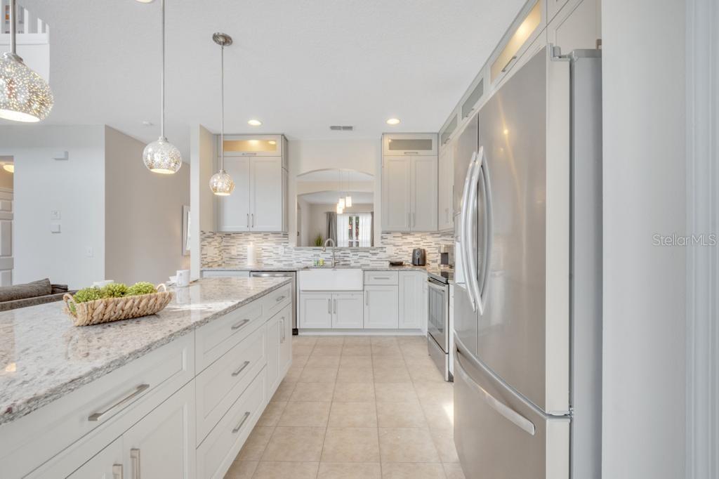 162 Cordova Avenue Davenport, FL 33897 - Photo 18 of 80 a large white kitchen with a large window appliances and cabinets