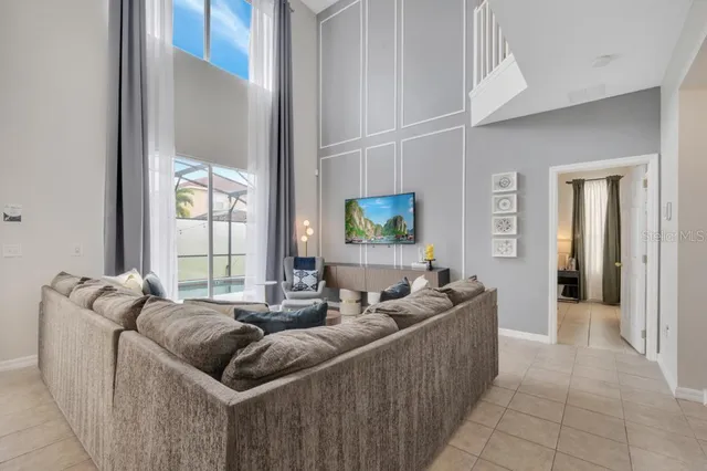 a bedroom with a bed ceiling fan and a wooden floor