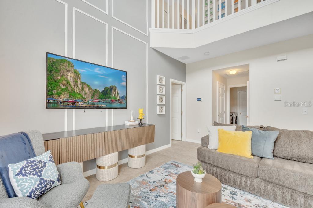 162 Cordova Avenue Davenport, FL 33897 - Photo 27 of 80 a living room with furniture and a painting on the wall