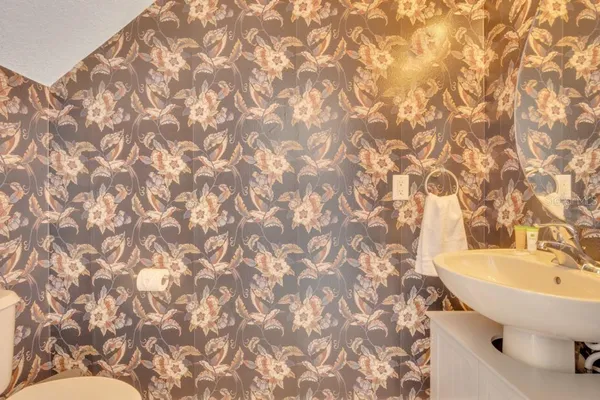 a bathroom with a sink a toilet and a mirror