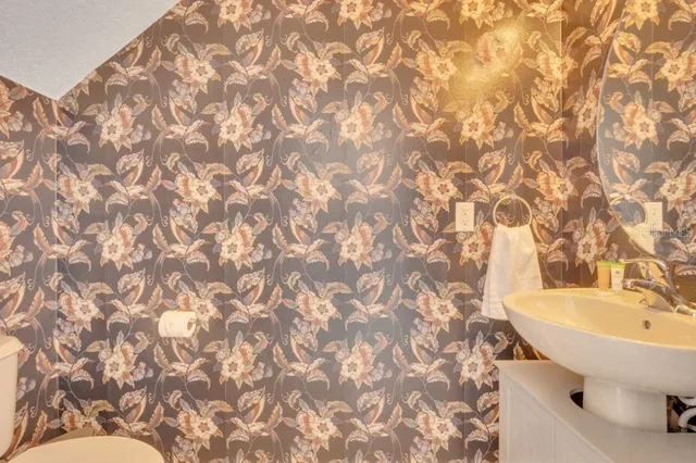 a bathroom with a sink a toilet and a mirror