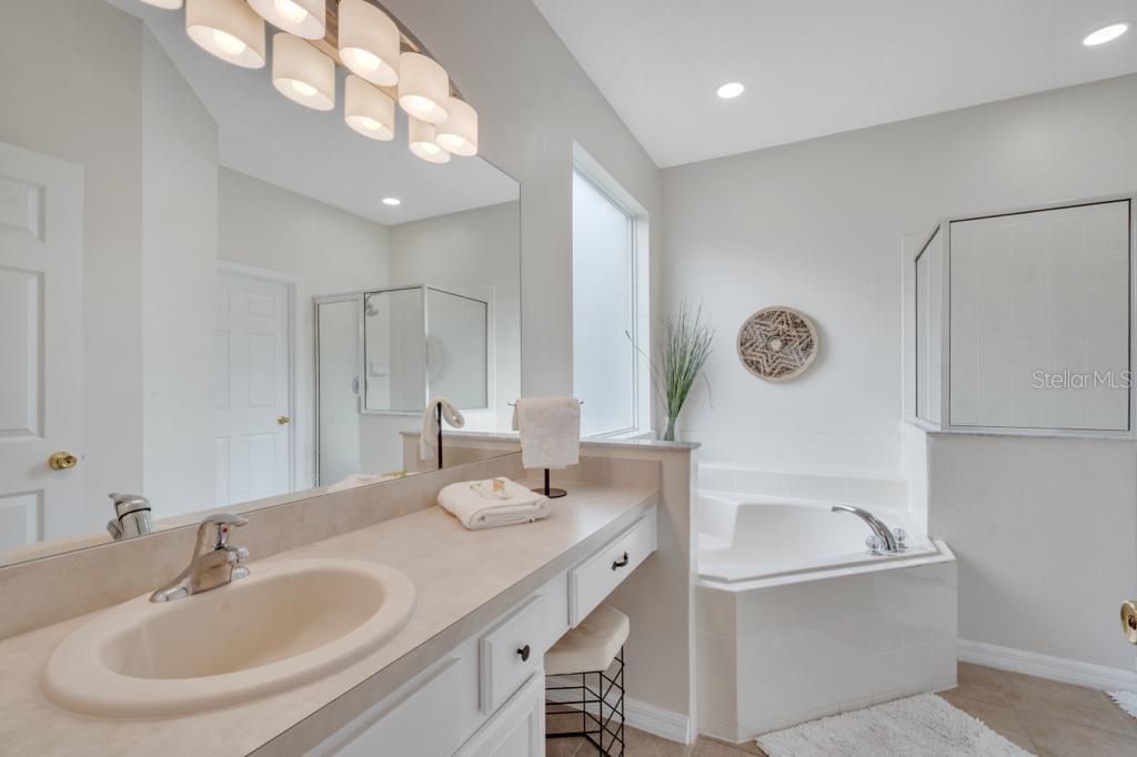 162 Cordova Avenue Davenport, FL 33897 - Photo 36 of 80 a bathroom with a tub sink and mirror