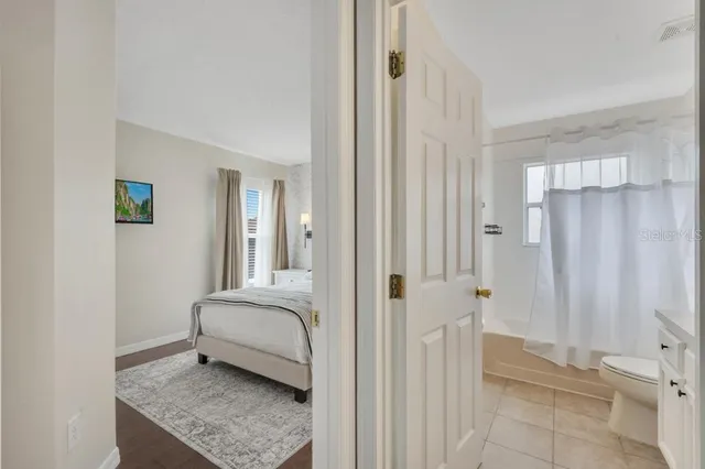 a bathroom with a sink toilet double vanity and shower