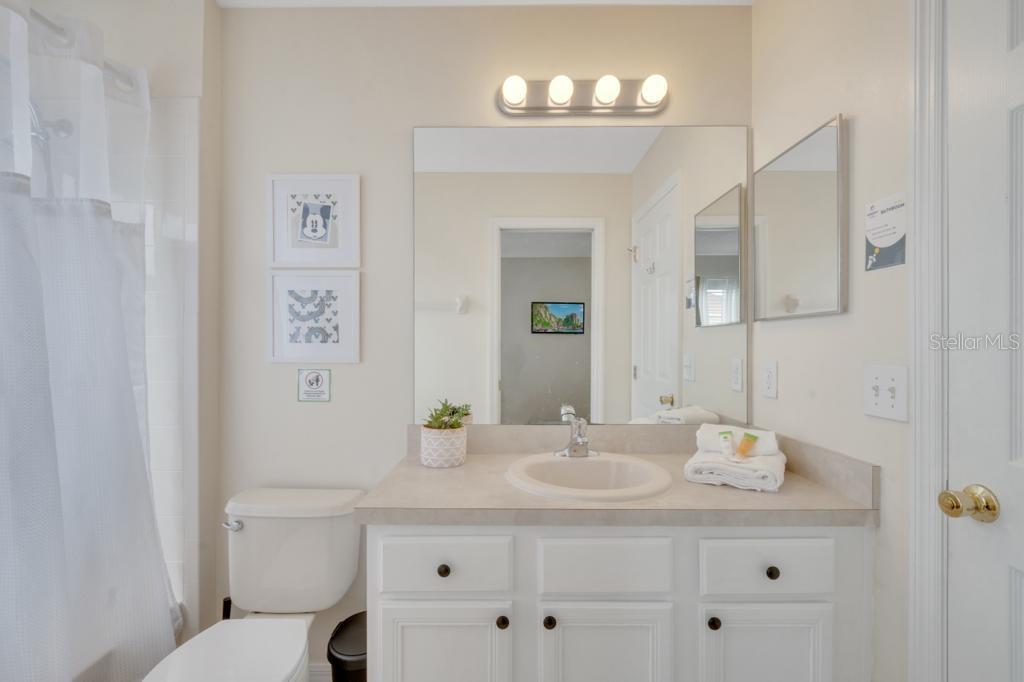 162 Cordova Avenue Davenport, FL 33897 - Photo 46 of 80 a bathroom with a sink a toilet and a mirror
