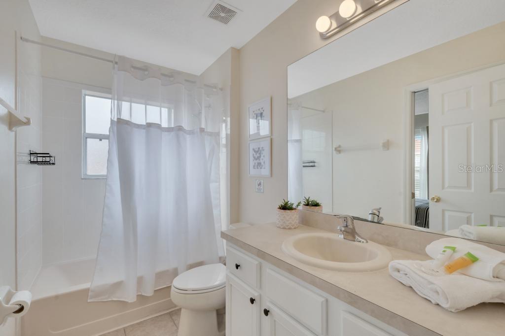 162 Cordova Avenue Davenport, FL 33897 - Photo 48 of 80 a bathroom with a granite countertop sink toilet and shower