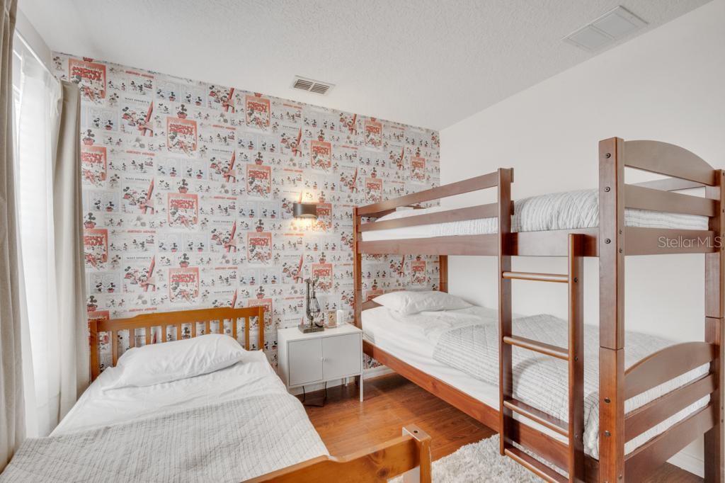 162 Cordova Avenue Davenport, FL 33897 - Photo 52 of 80 a bedroom with a bed and a table in it