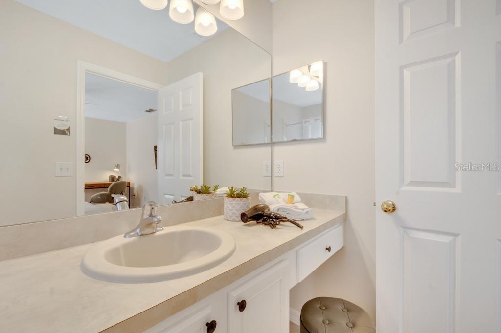 162 Cordova Avenue Davenport, FL 33897 - Photo 56 of 80 a bathroom with a sink and a mirror