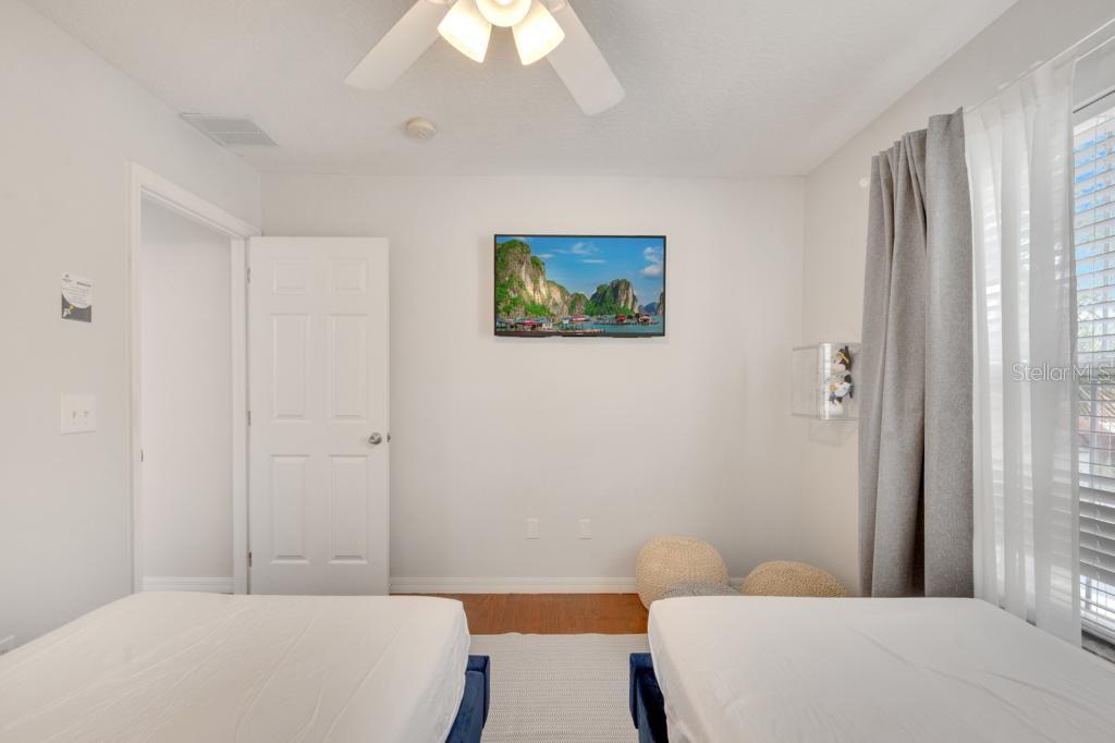 162 Cordova Avenue Davenport, FL 33897 - Photo 69 of 80 a bedroom with a bed and a painting on the wall