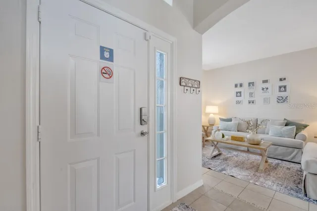 a living room with furniture and large windows