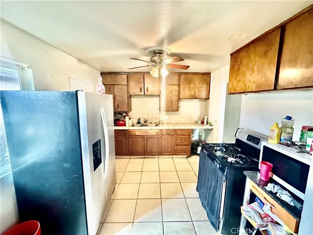 a kitchen with stainless steel appliances a stove a refrigerator and a sink