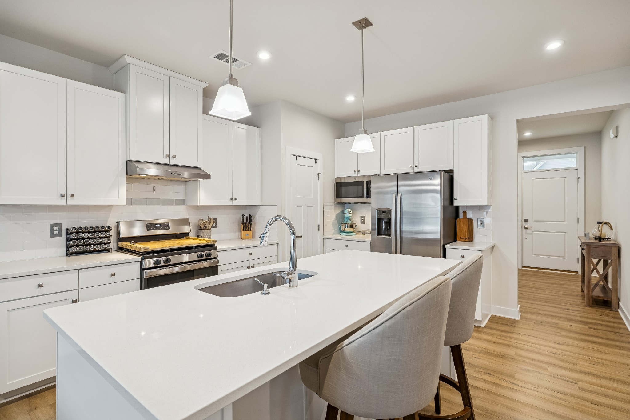 809 Mill Tree Court Smyrna, TN 37167 - Photo 9 of 42 a kitchen with stainless steel appliances a stove a sink a kitchen island with chairs and wooden cabinets