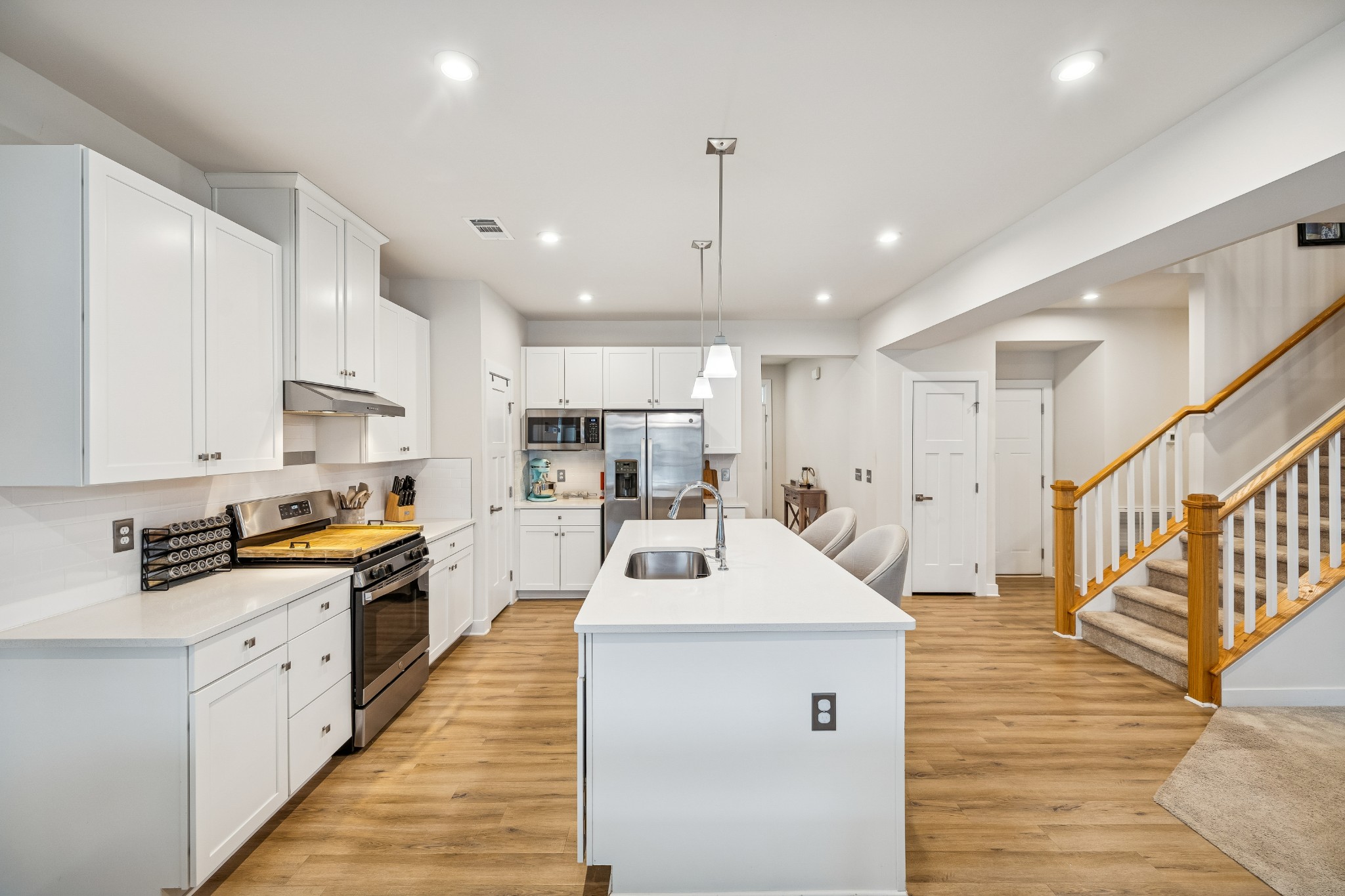 809 Mill Tree Court Smyrna, TN 37167 - Photo 10 of 42 a kitchen with counter top space a sink wooden floor and stainless steel appliances