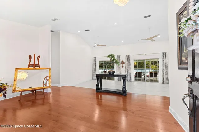 a kitchen with stainless steel appliances kitchen island granite countertop a sink and dishwasher with wooden floor