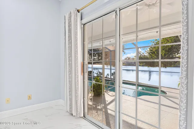 a view of a swimming pool with a lot of potted plants