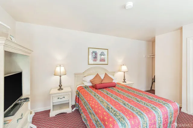 a bedroom with a bed and a couch